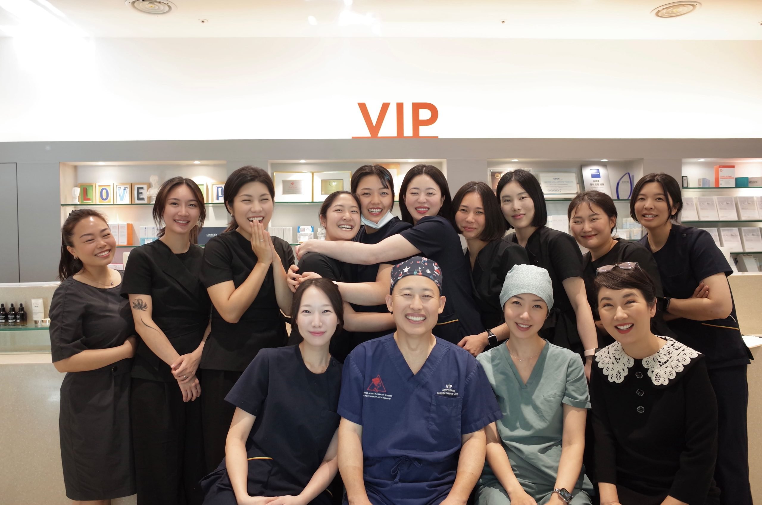 Group photo of the VIP Plastic Surgery medical team in Korea, including surgeons, nurses, and staff smiling together.